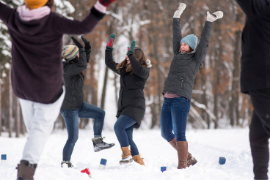 Group of friends playing winter Kubb 