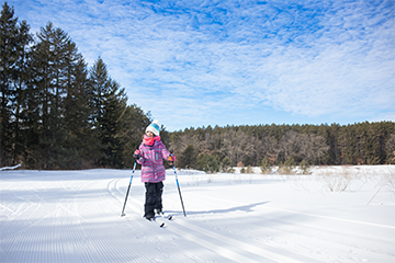 A young girl cross country skiing at Lowes Creek County Park 