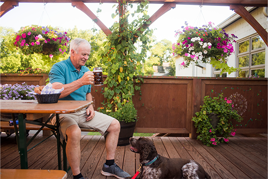 A man and dog enjoying a beer at Lazy Monk beer garden 