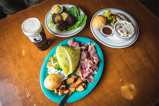 a spead of Irish food for St. Patricks Day at Dooley's Pub, consisting of cabbage, corned beef, Guinness beer, Scotch eggs, and more 