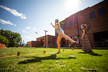 Two girls playing Kubb at The Brewing Projekt 
