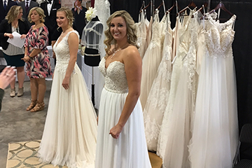 two girls posing in wedding dresses at the wedding fair in Eau Claire 
