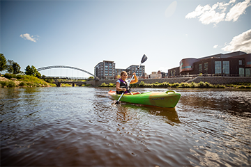 A woman kayaking at the confluence of the Eau Claire and Chippewa Rivers 