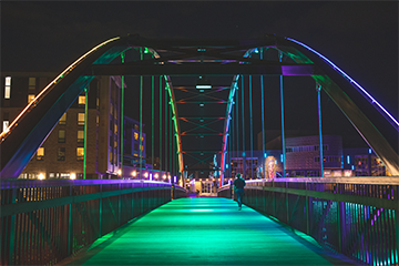 Haymarket Plaza bridge lit up at night 