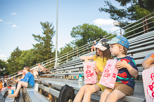 A young boy and girl eating popcorn at Eau Claire Express baseball game 