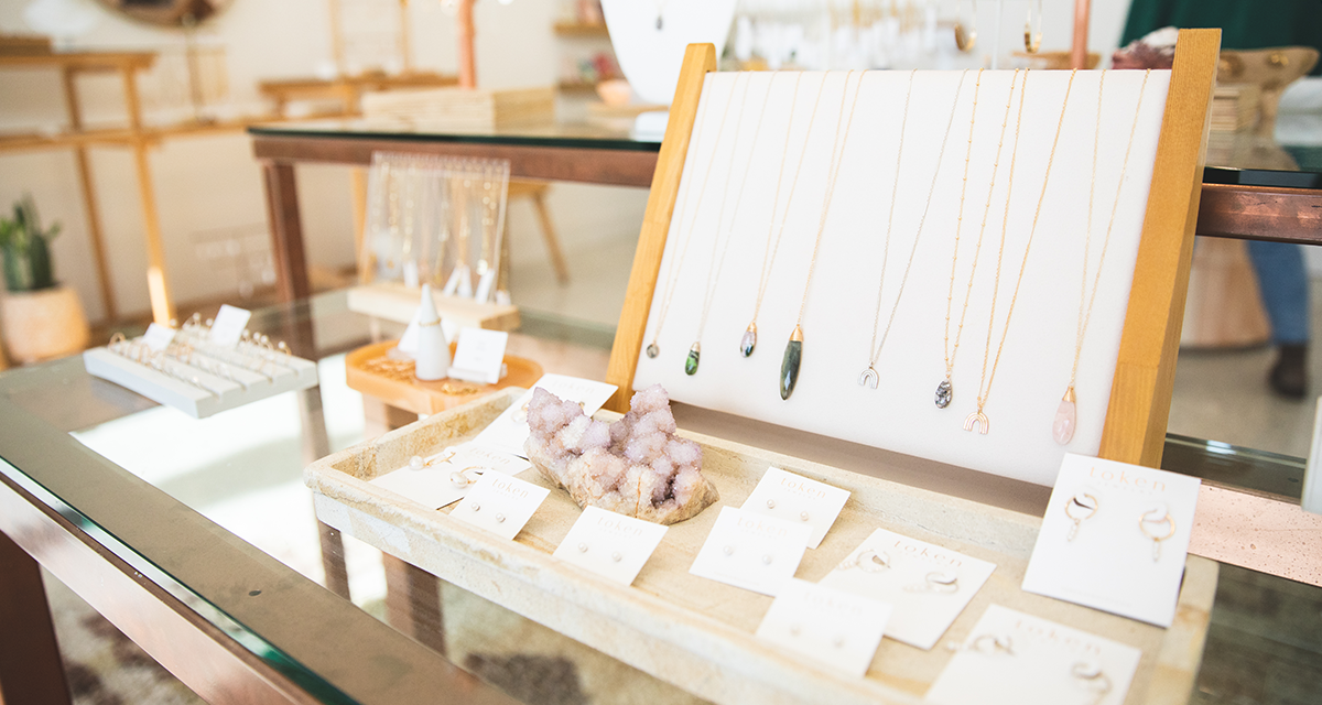 a selection of handmade necklaces, earrings, rings, and other jewelry at Token Jewelry in Eau Claire 