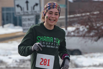 A female running the Shamrock Shuffle at UW-Eau Claire 