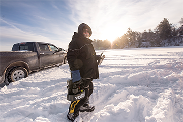 An ice fishermen standing on Lake Wissota at the annual JIG's Up Ice Fishing Contest 