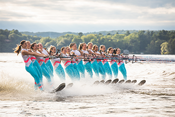 a group of girls all water skiing  in a line at the Ski Sprites events in Eau Claire 