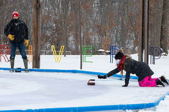 man and woman playing crokicurl in River Prairie  