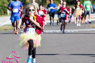 a young girl in a tutu running in the Girls on the Run 5k in Eau Claire 